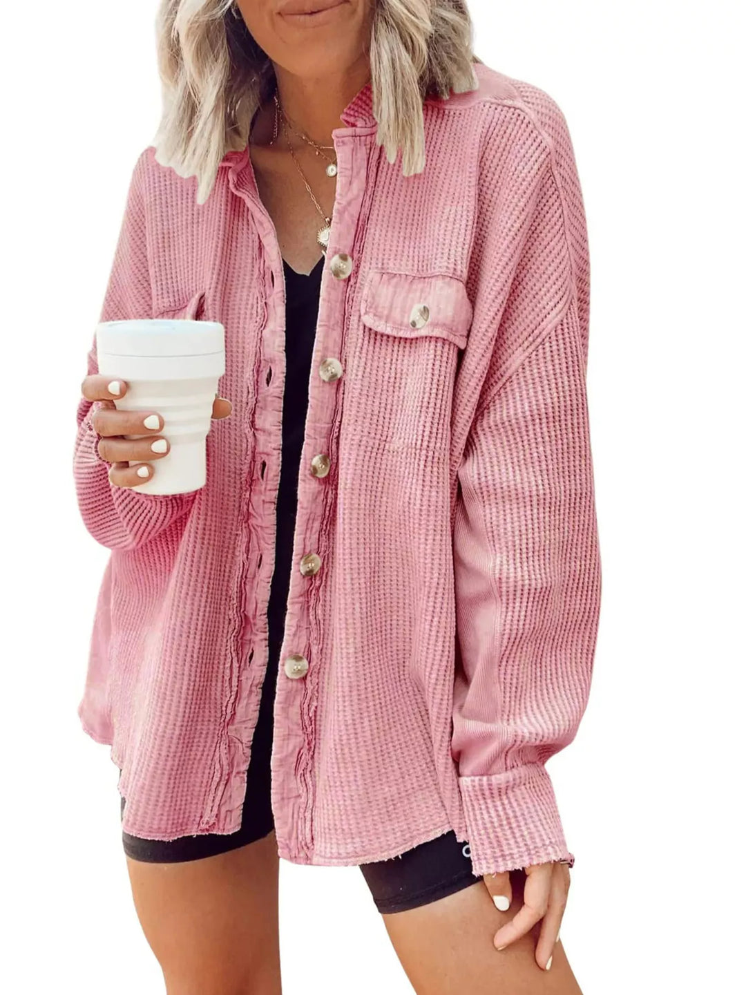 Pink oversized button up shacket worn with a black tank and shorts