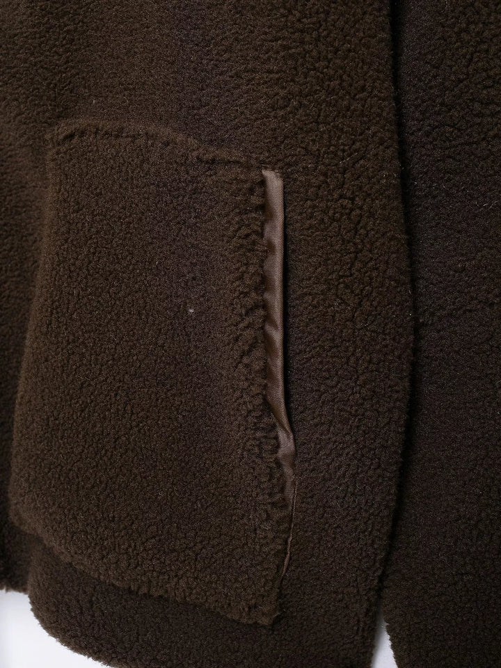 Stand collar full zip drawcord hem in coffee-ribbed, close-up detail