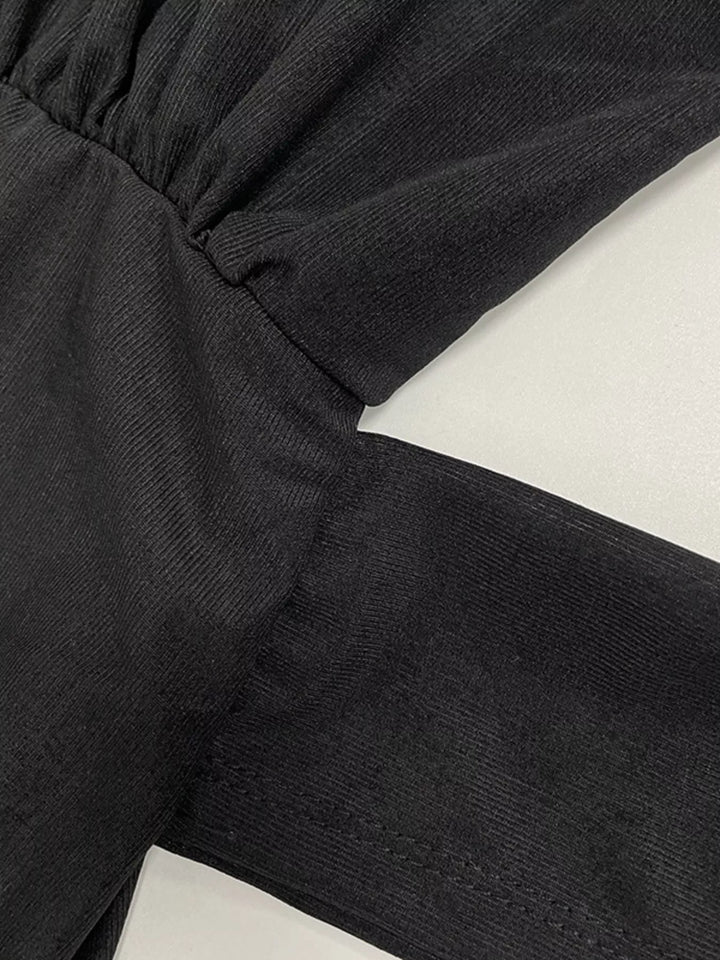 Close-up of the button down front on the black shirt dress