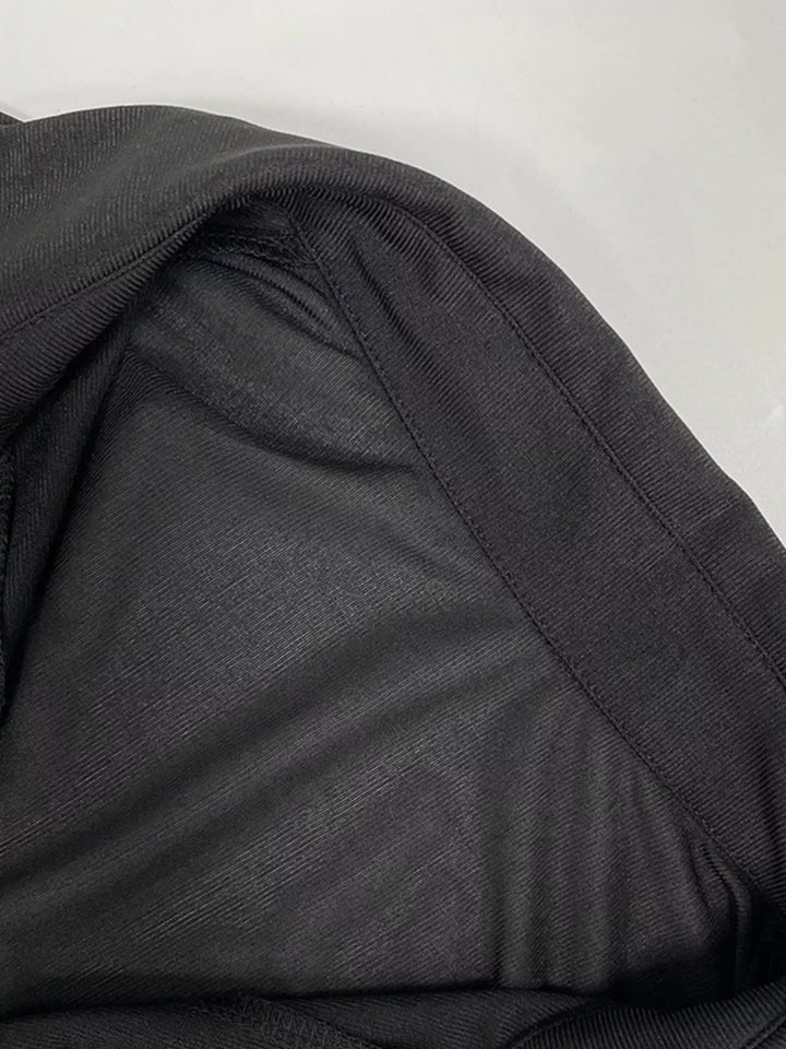 Close-up of the sheer fabric on the black shirt dress