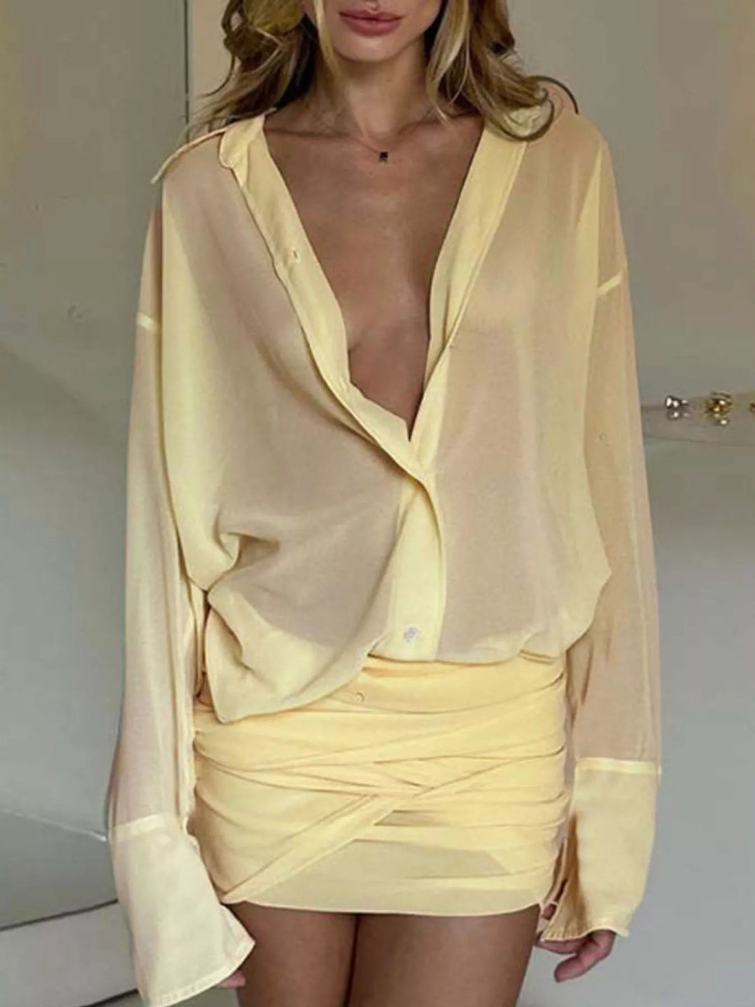 Pastel yellow shirt dress worn on a model, showing the button down front