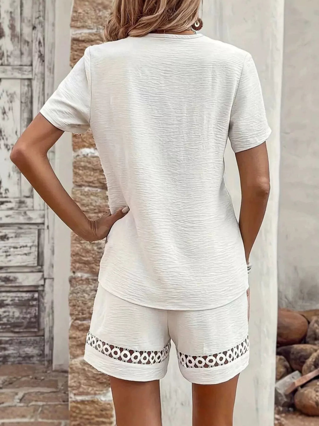White short set back view with lace trim along the shorts hem