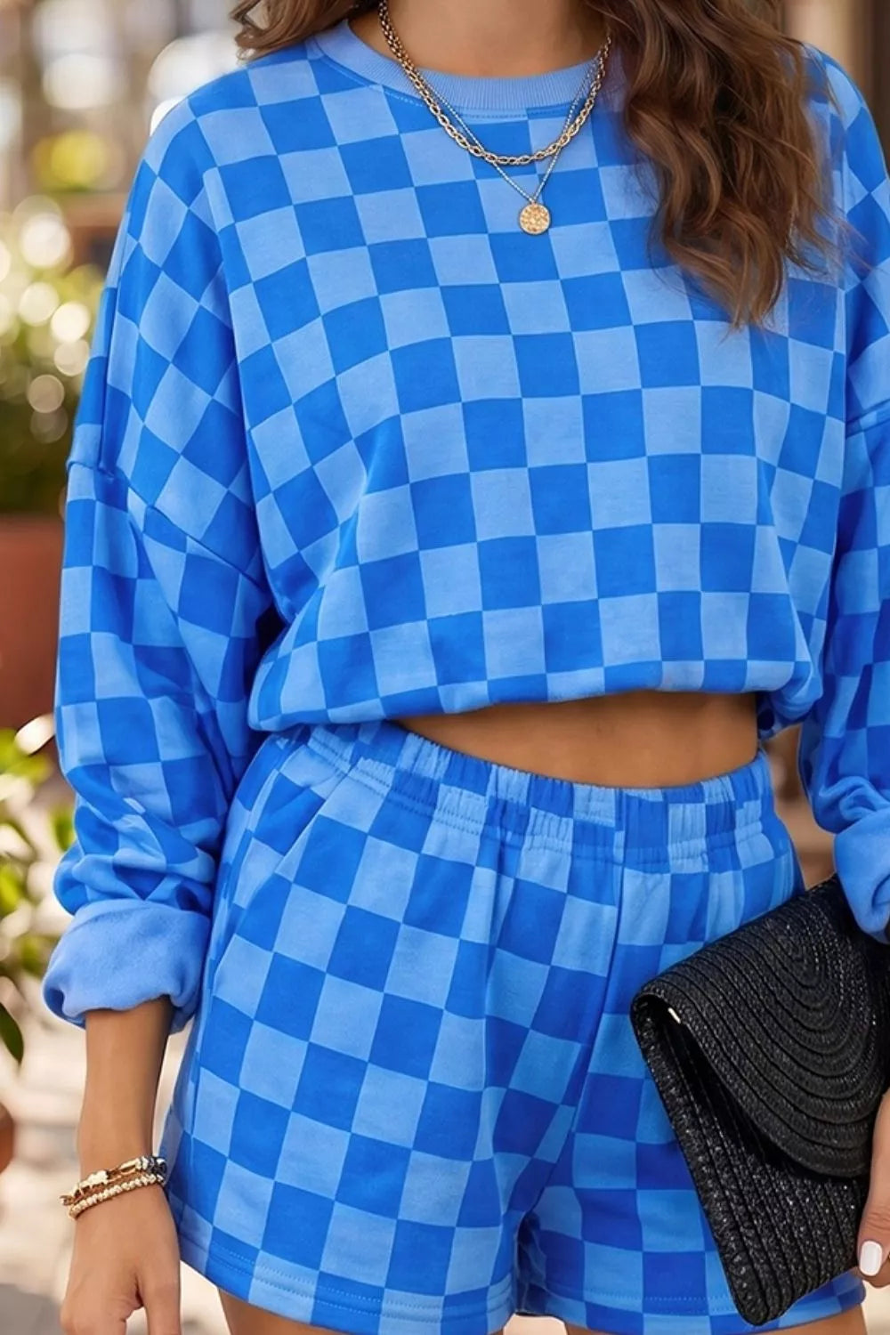 Close-up of the blue checkerboard print terry texture top and shorts