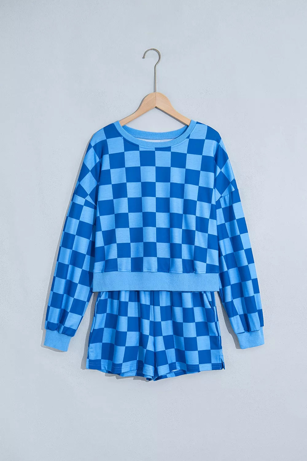 Blue checkerboard cropped top and shorts set on a hanger, front view