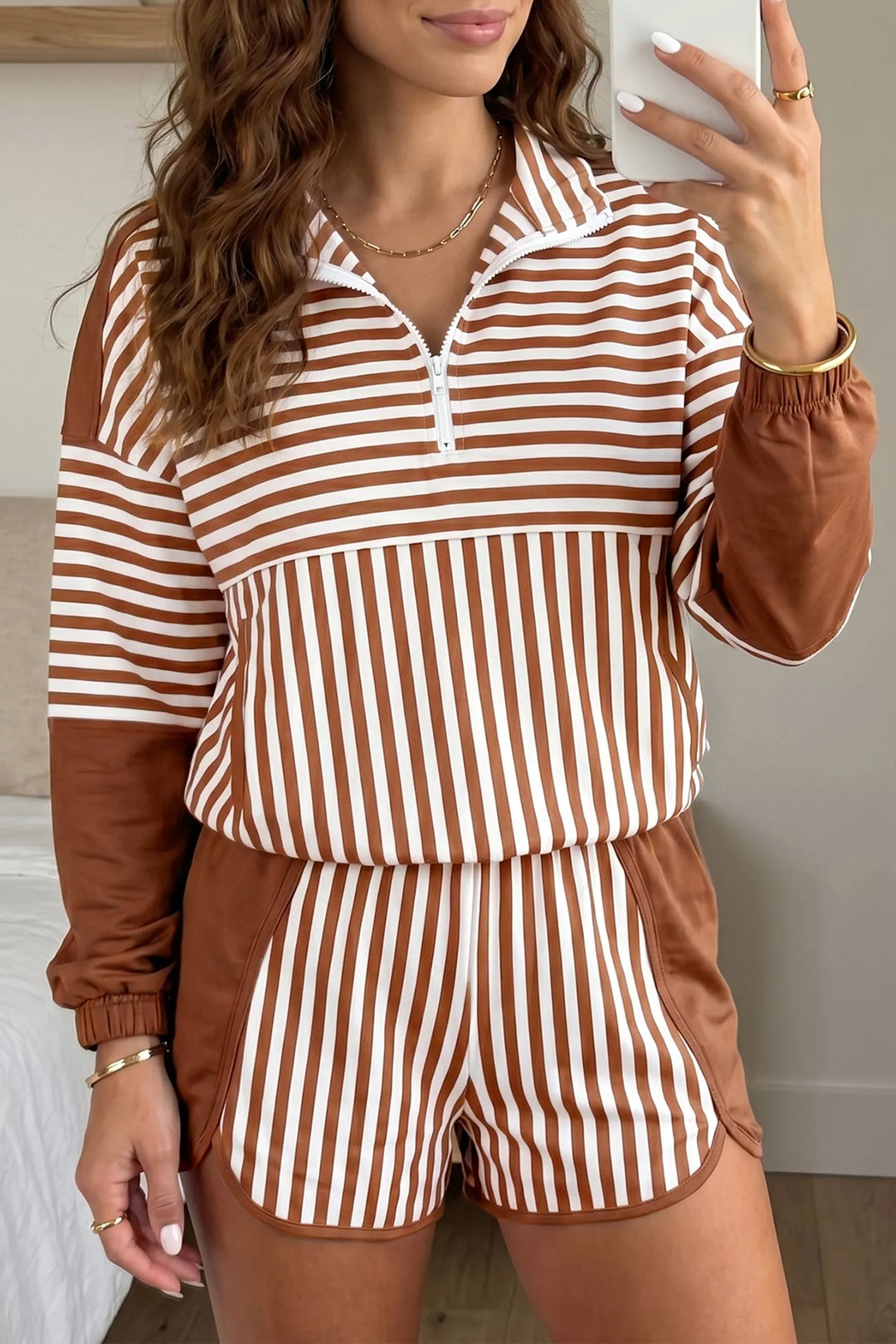 Brown stripe quarter zip pullover with matching shorts, front view with long wavy hair