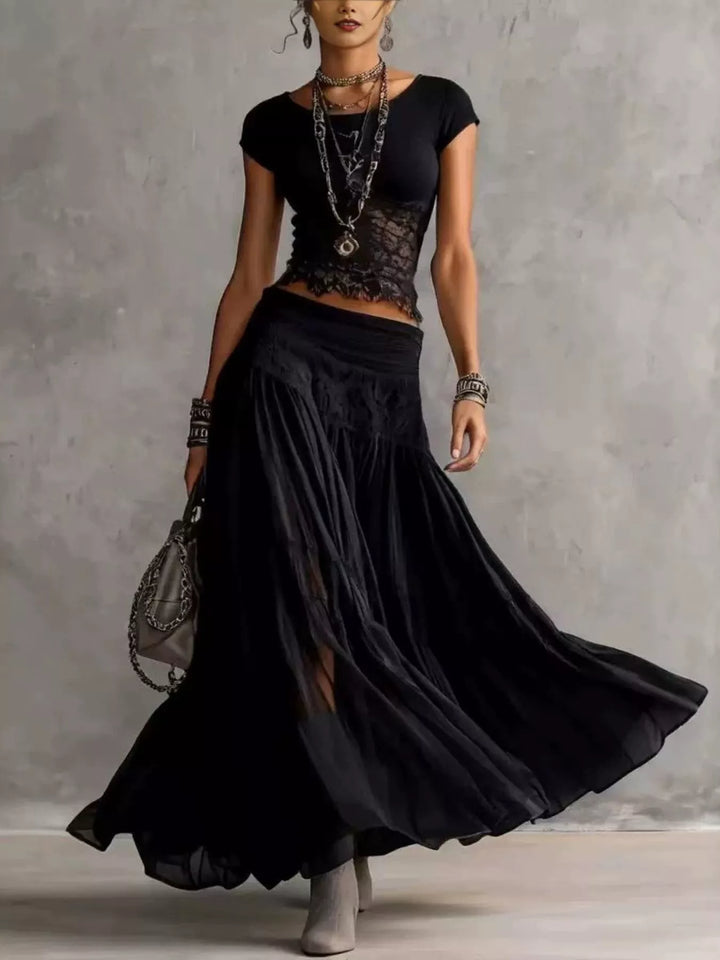 Black lace top and tiered sheer maxi skirt set, full-length view with a handbag