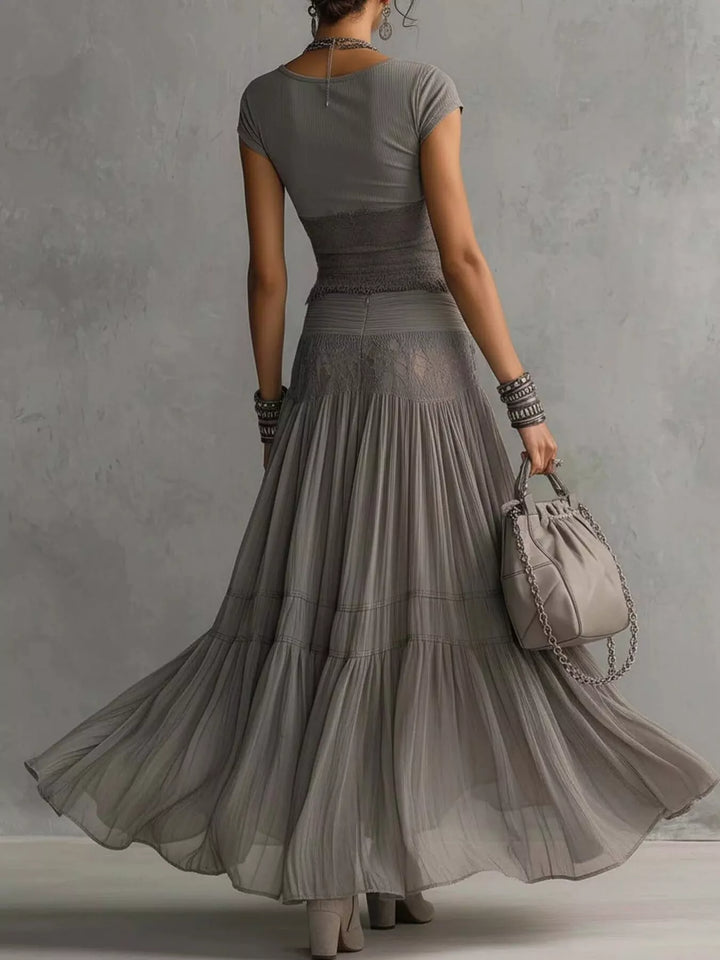 Back view of the gray short sleeve top and tiered flowing maxi skirt
