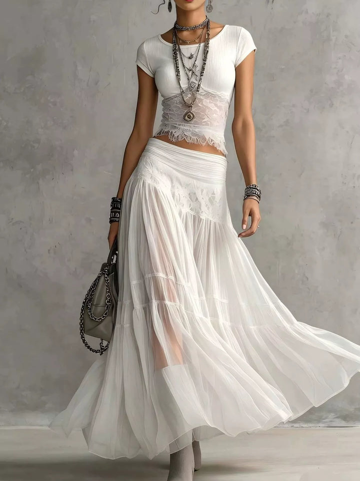 White lace top and tiered sheer maxi skirt set, full-length walking pose