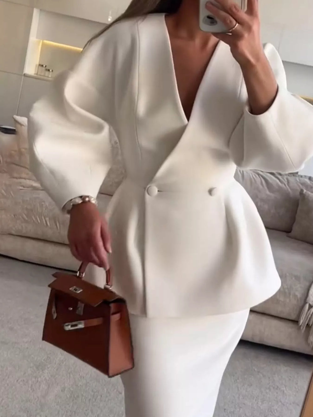 White peplum blazer and pencil skirt set worn with a brown handbag