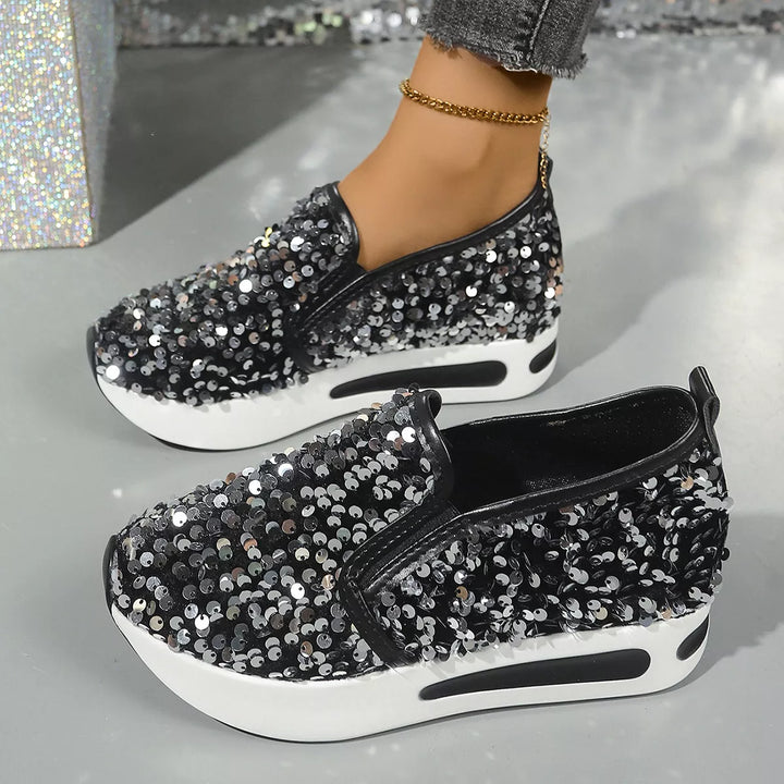 Pair of black sequin platform slip on sneakers shown from the side and top