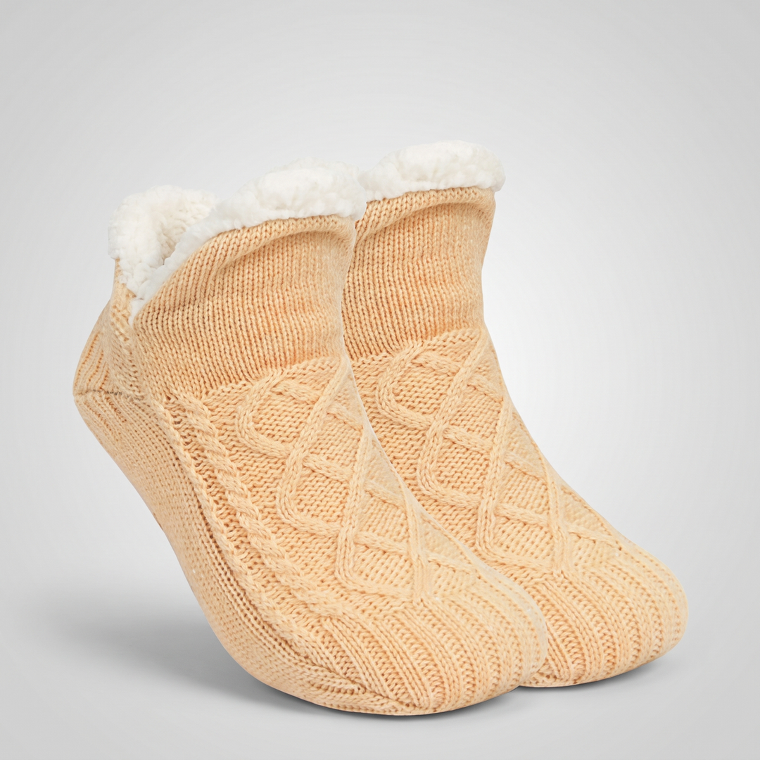 Pair of beige cable knit slipper socks with folded fleece cuff