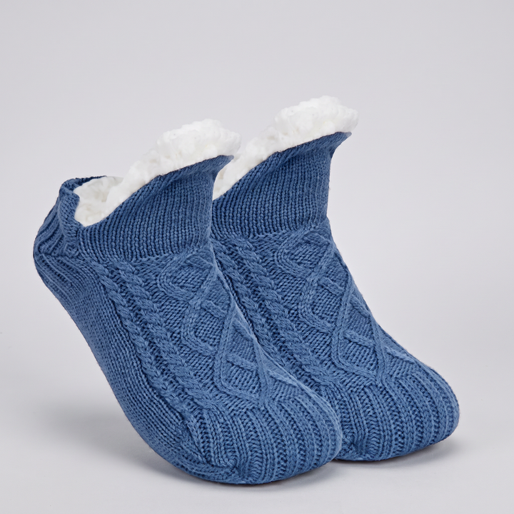 Pair of blue cable knit slipper socks with folded fleece cuff