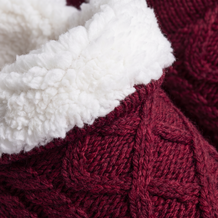 Close-up of the burgundy cable knit and fleece lining