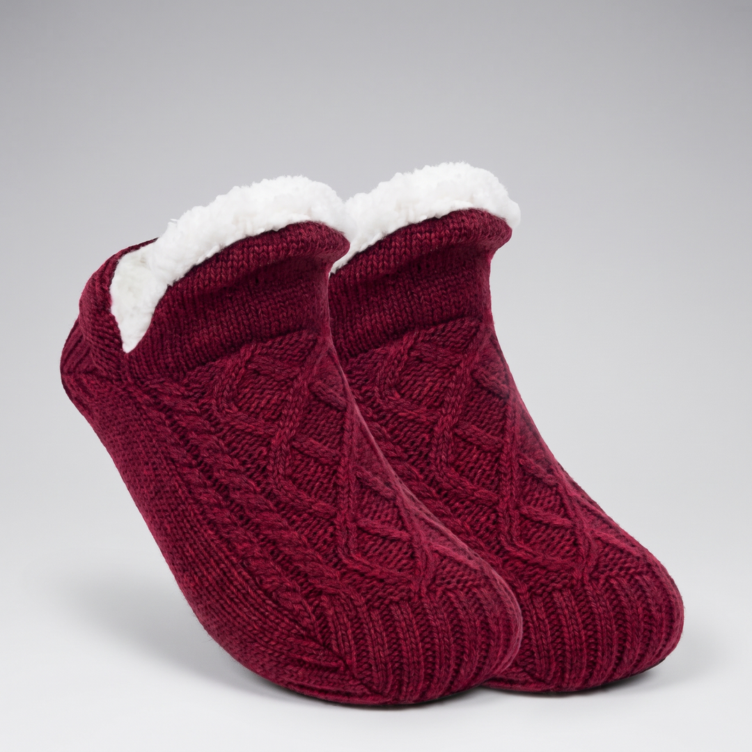 Pair of burgundy cable knit slipper socks with folded fleece cuff