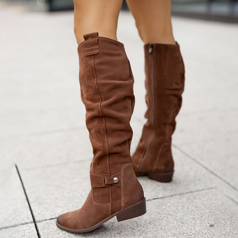 Brown slouchy knee high boot showing the ankle strap with stud