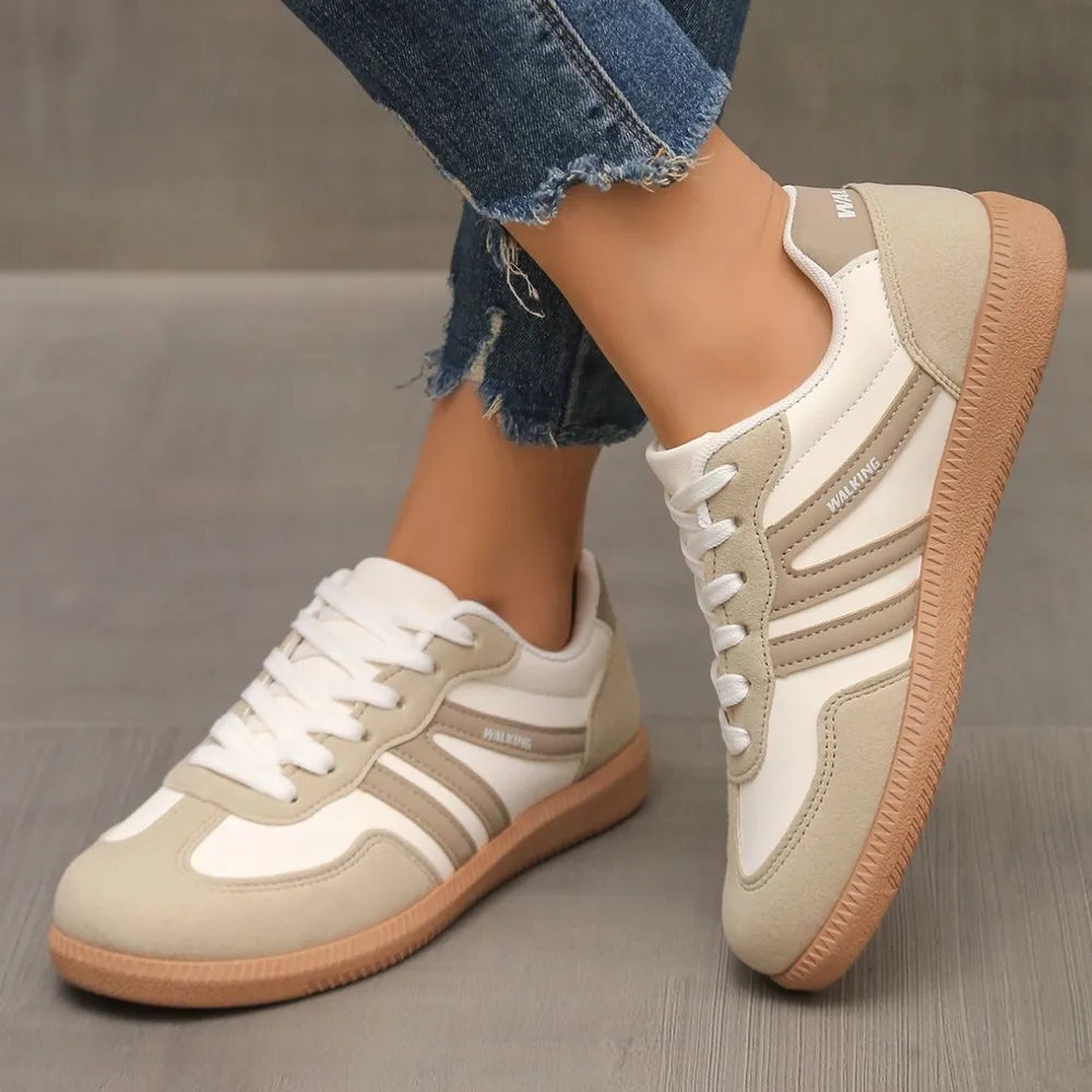Cream retro low top sneakers with beige contrast stripes, angled side view