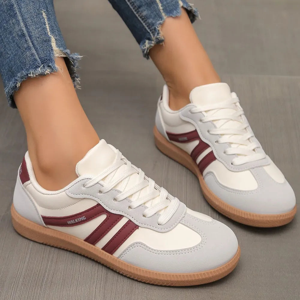 Gray and burgundy retro low top sneakers with white laces, side angle