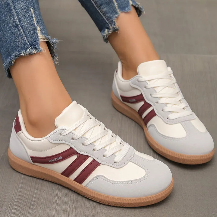 Gray and burgundy retro low top sneakers with white laces, side angle