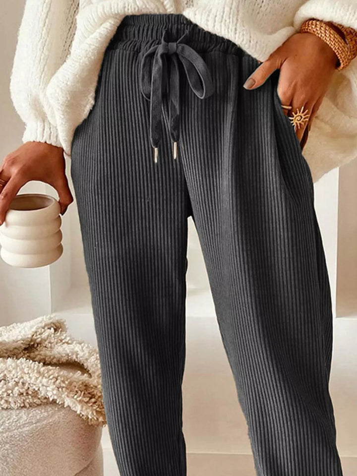 Close-up of the charcoal ribbed pants waist tie and pocket