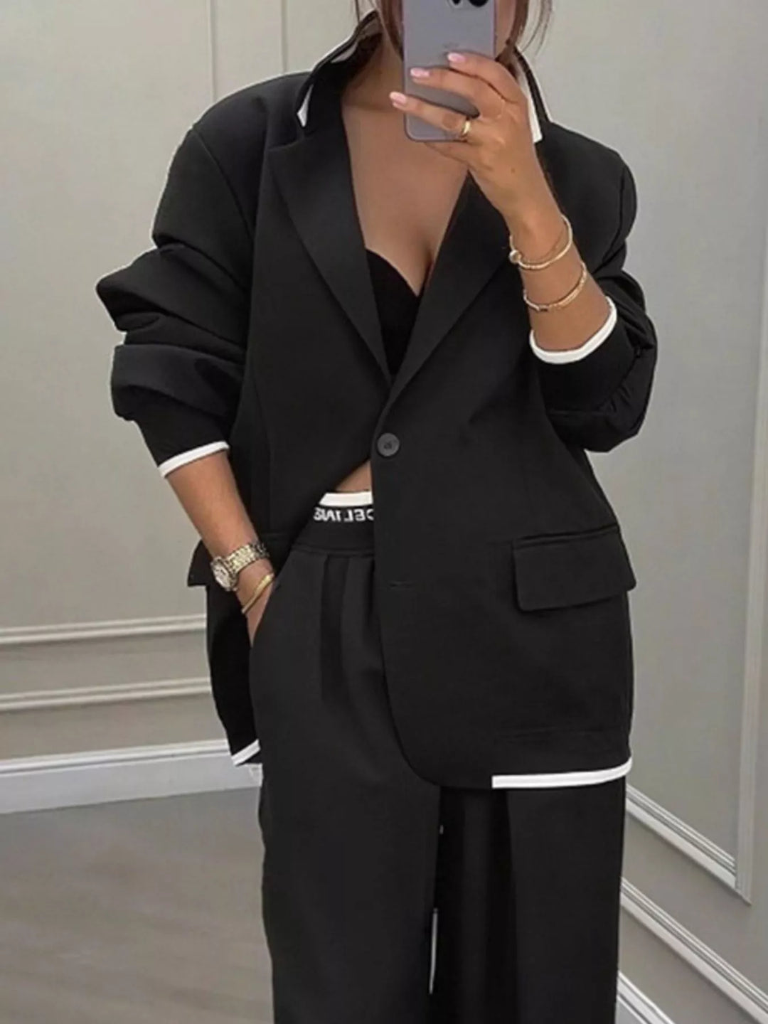 Oversized one button blazer and wide leg pants in black, close-up detail