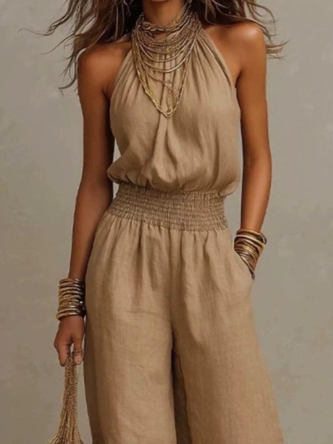 Tan summer jumpsuit, close view of the halter neck and smocked waist