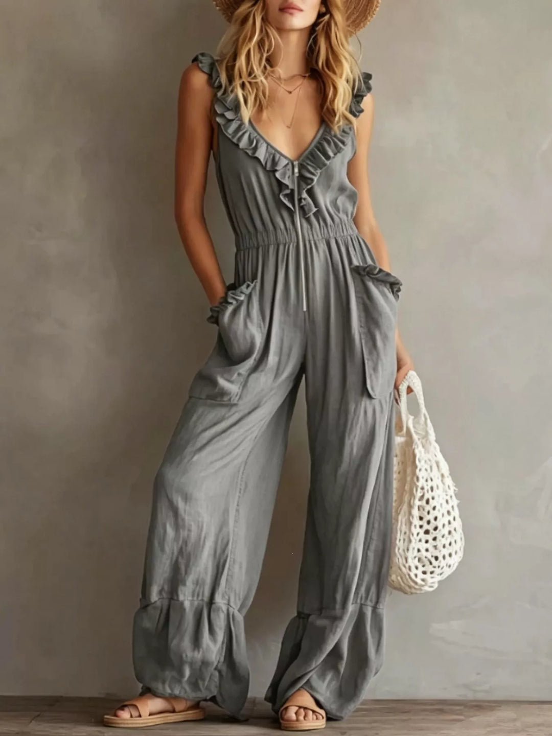 Gray wide leg jumpsuit with ruffled neckline and cinched waist, full length