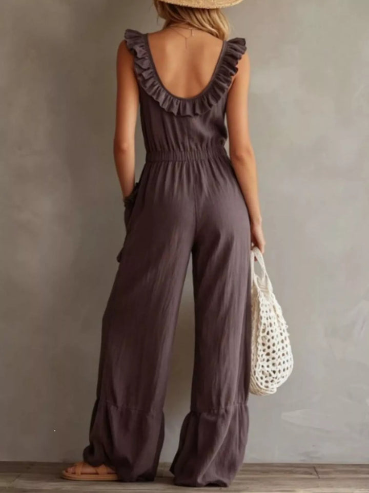 Back view of the taupe sleeveless jumpsuit with scooped back and ruffle trim