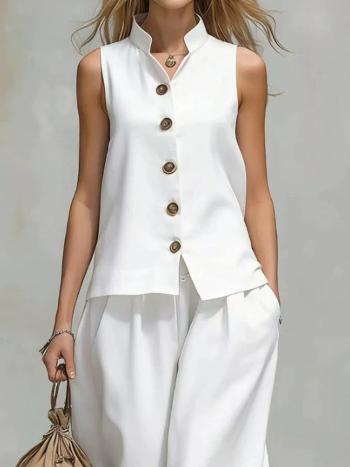 Front view of the white button vest with stand collar over wide leg pants