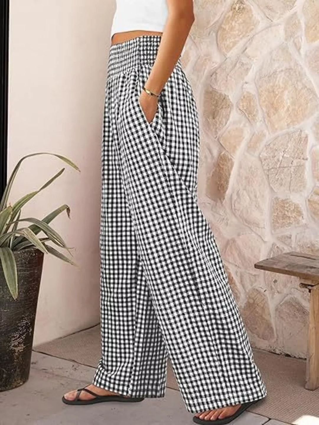 Black gingham smocked waist pants in side view with sandals
