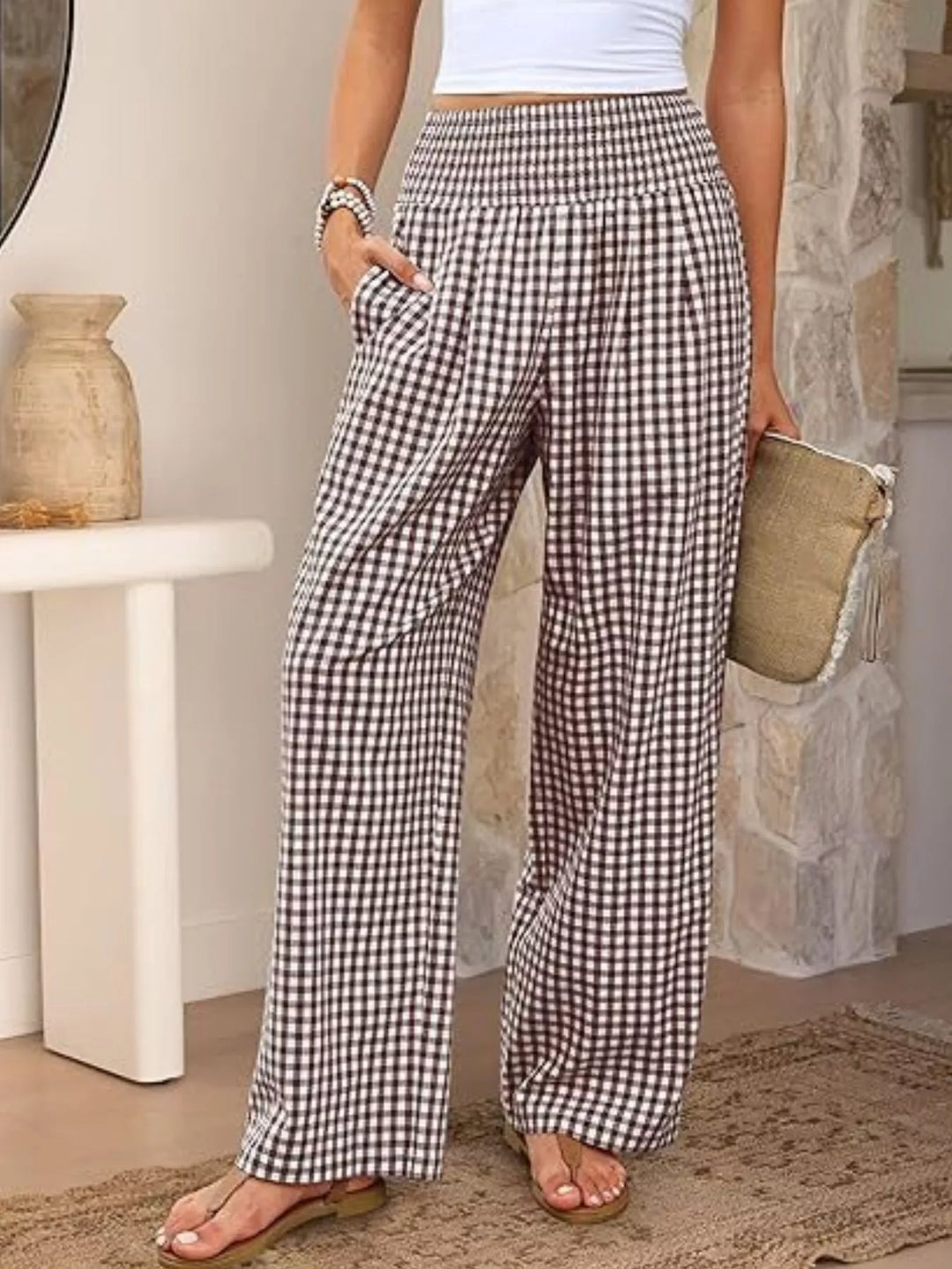 Brown gingham wide leg pants with smocked high waist, front view with clutch