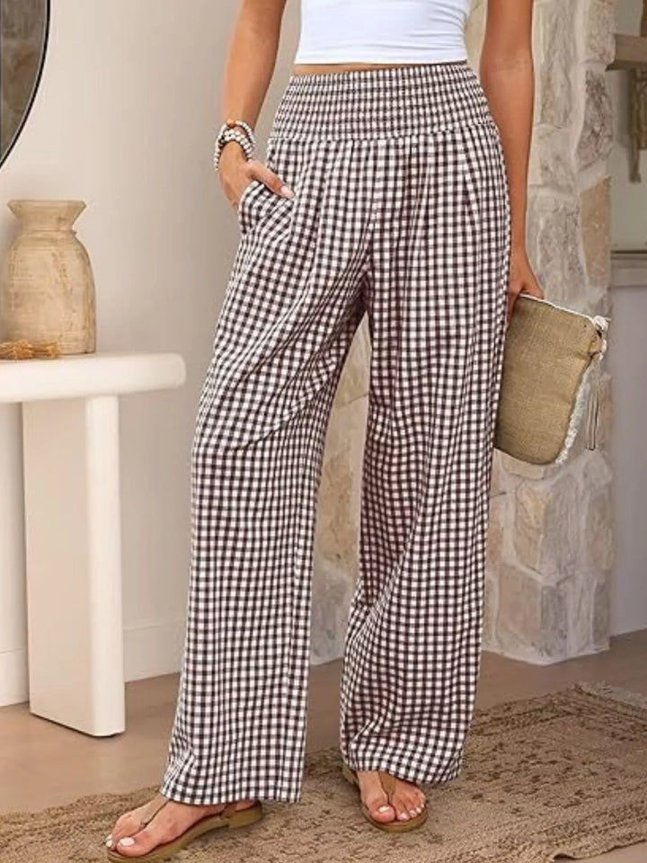 Brown gingham wide leg pants with smocked high waist, front view with clutch
