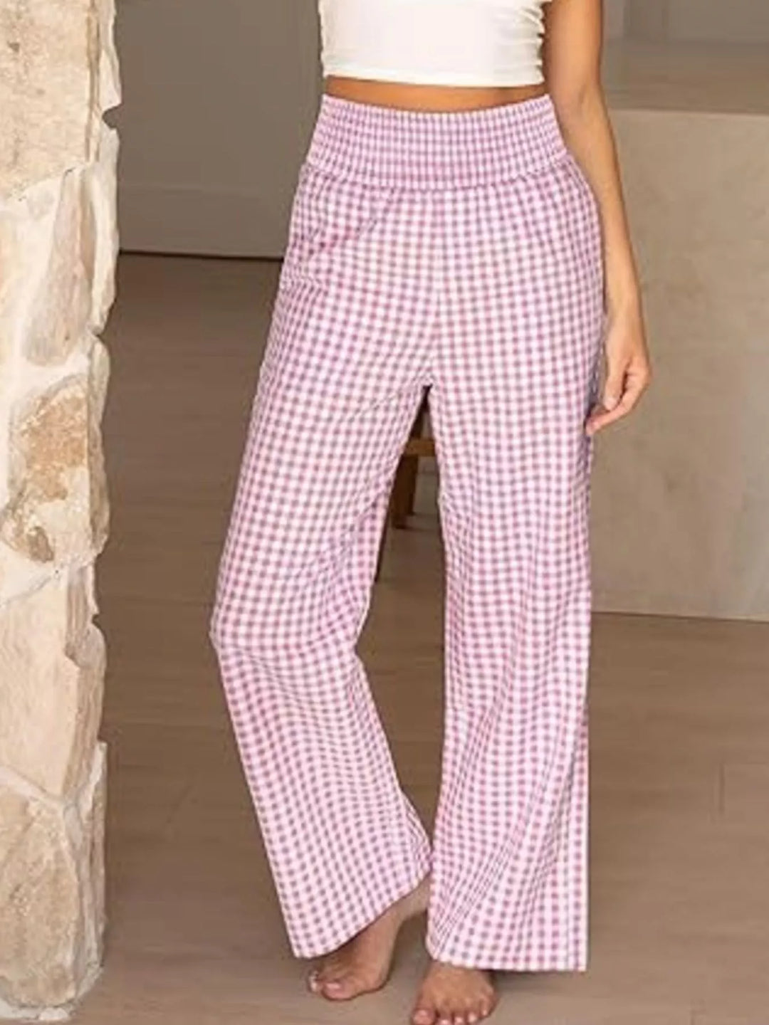 Pink gingham high waist pants with smocked waistband, barefoot front view