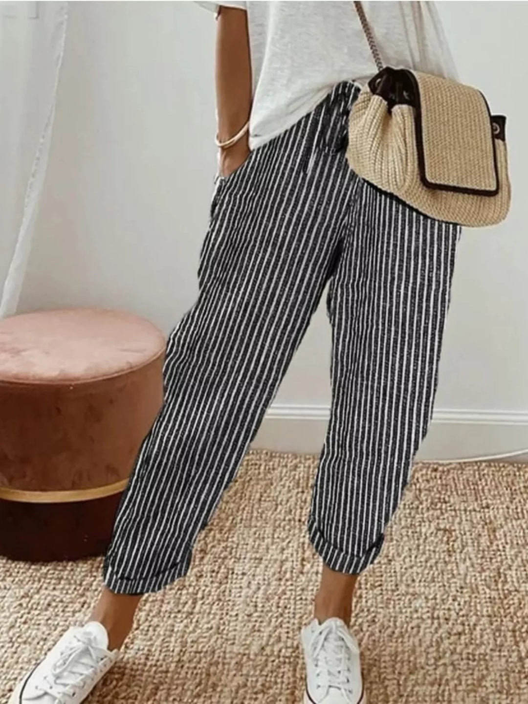 Black striped cropped summer pants worn with a white tee and sneakers