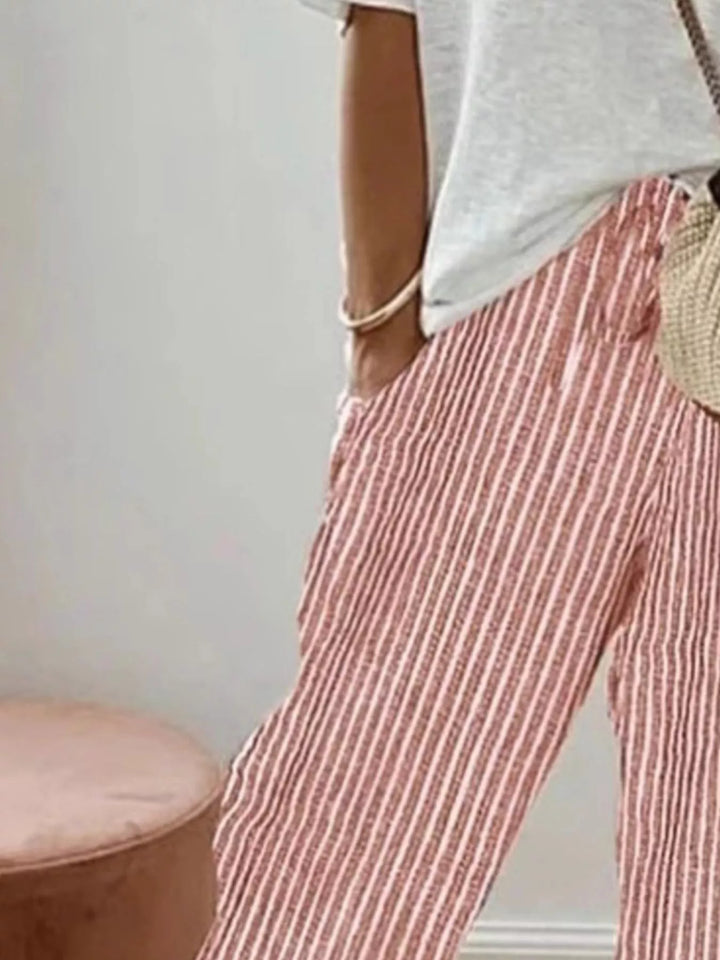 Close-up of the coral striped tapered pants with drawstring waist