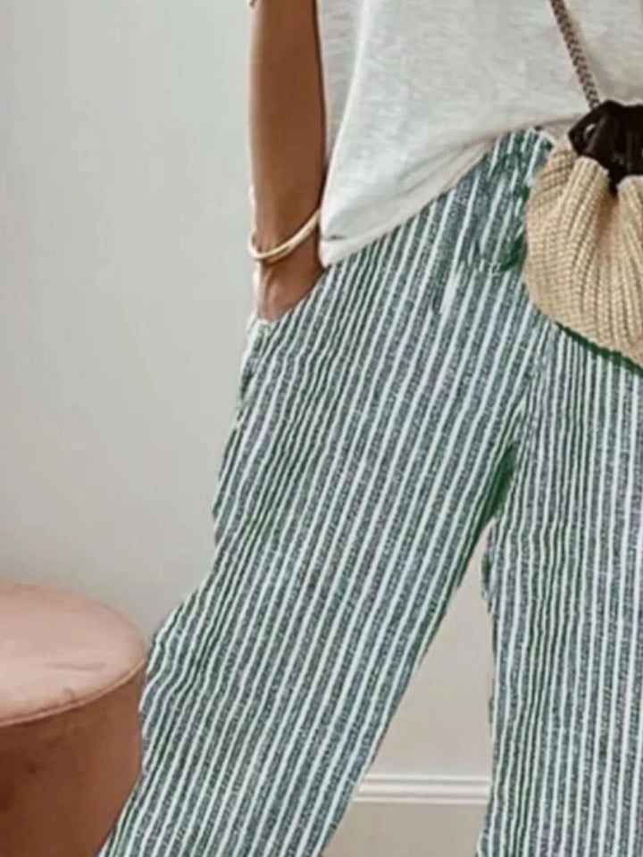Close-up of the green striped drawstring pants and tapered leg