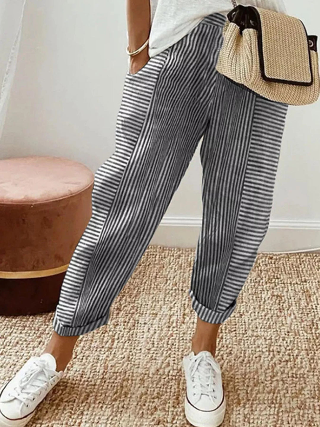 Black striped summer pants with elastic waist, styled with white sneakers
