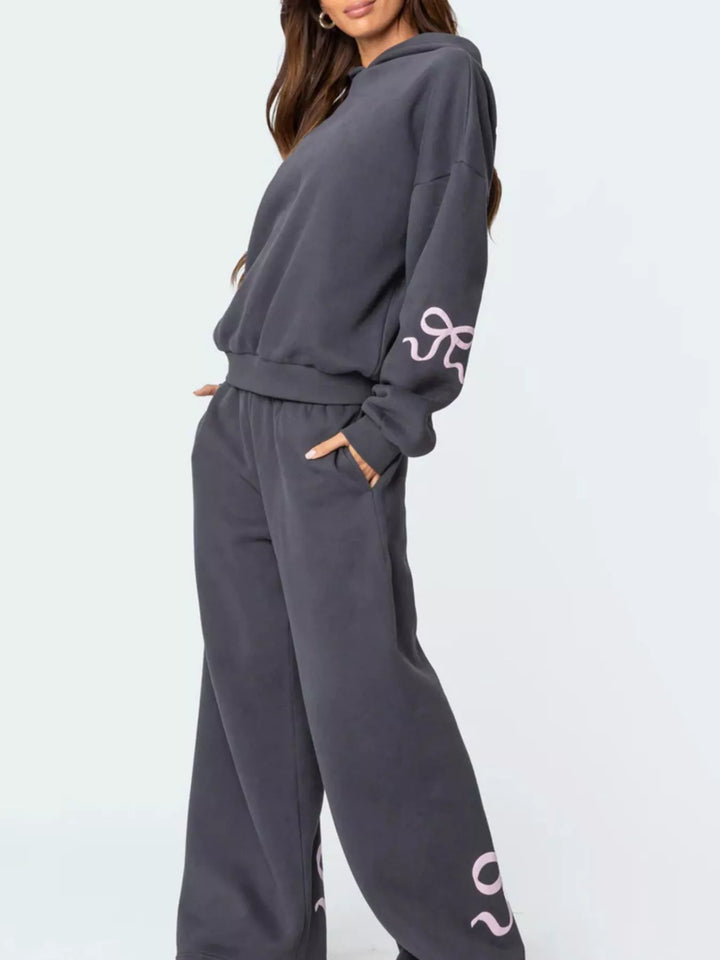 Bow print hoodie and wide leg sweatpants in grey, styled on model 2