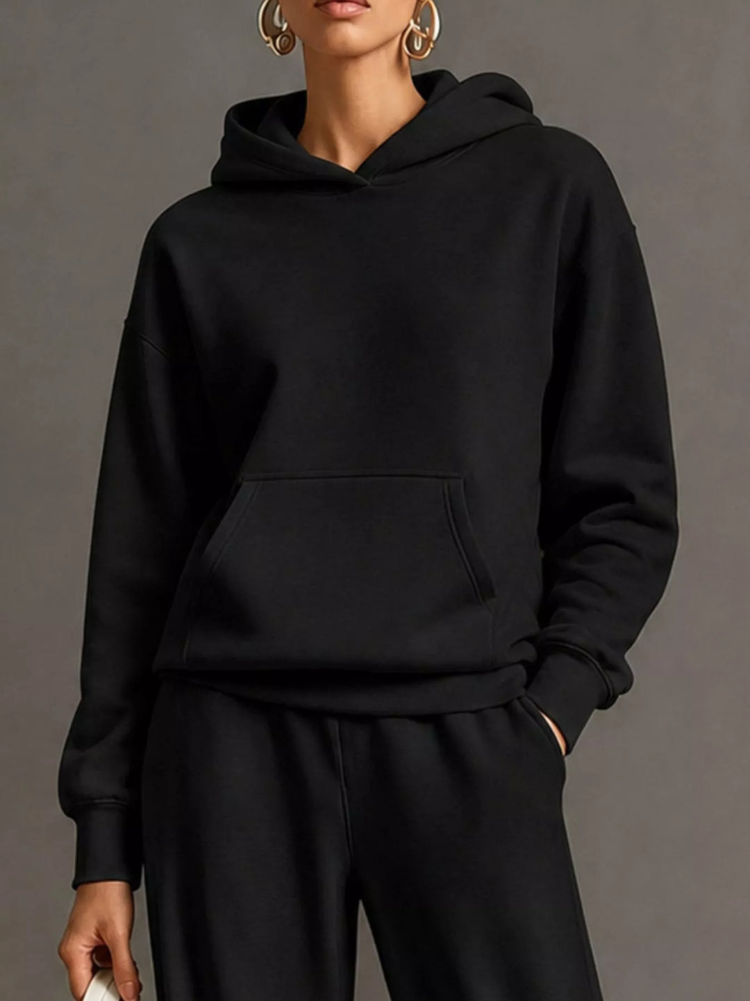 Kangaroo pocket hoodie and wide leg pants in black, close-up detail