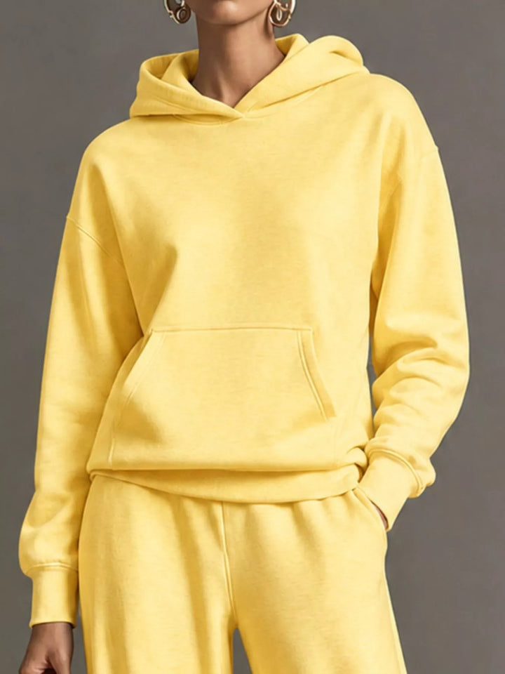Kangaroo pocket hoodie and wide leg pants in yellow, close-up detail