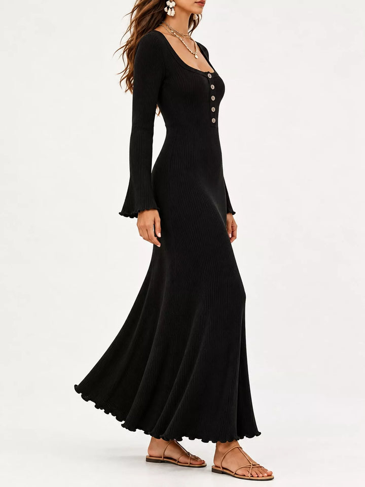 Black sweater dress worn on a model, showing the button front