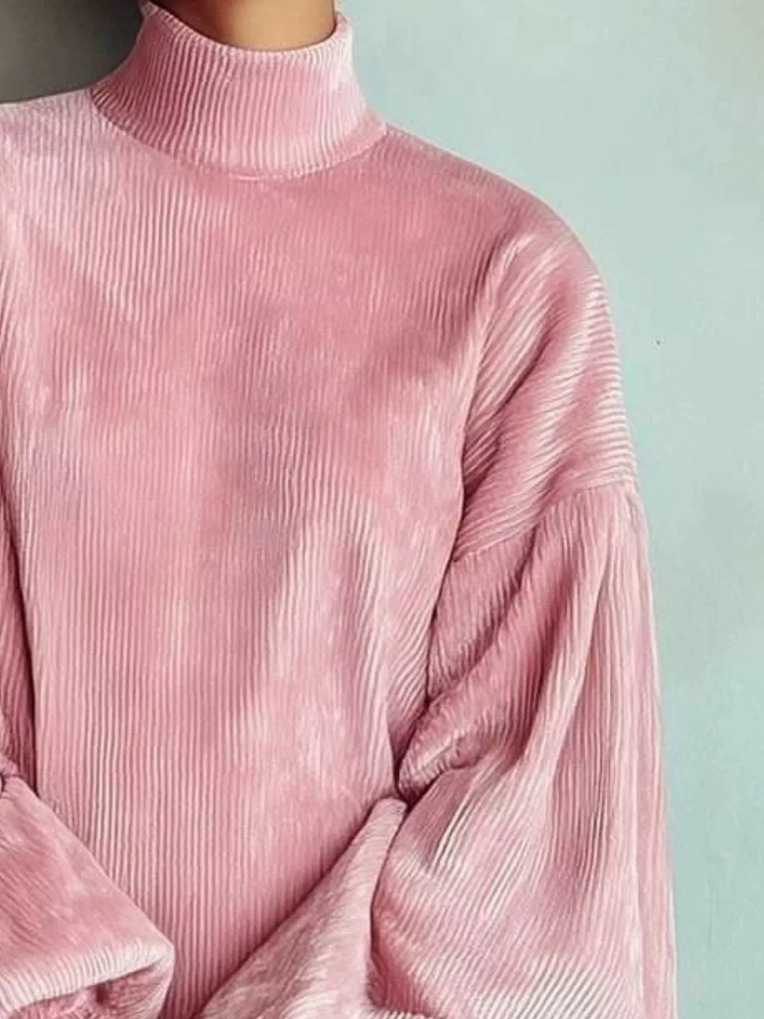Pink sweater dress worn on a model, showing the ribbed knit look