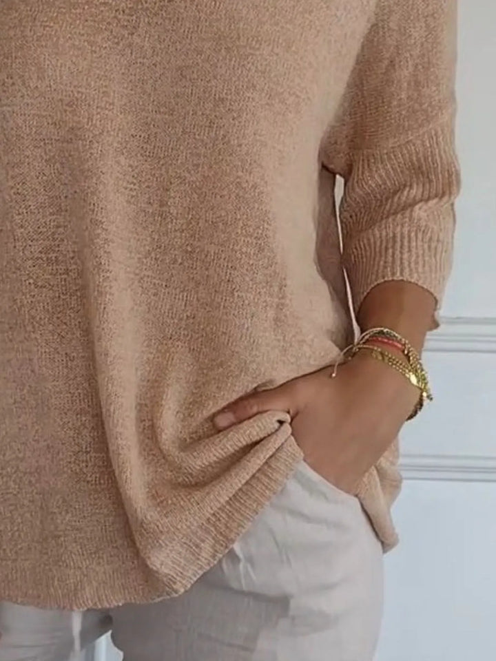 Camel sweater detail showing the ribbed 3/4 sleeve cuff and hem