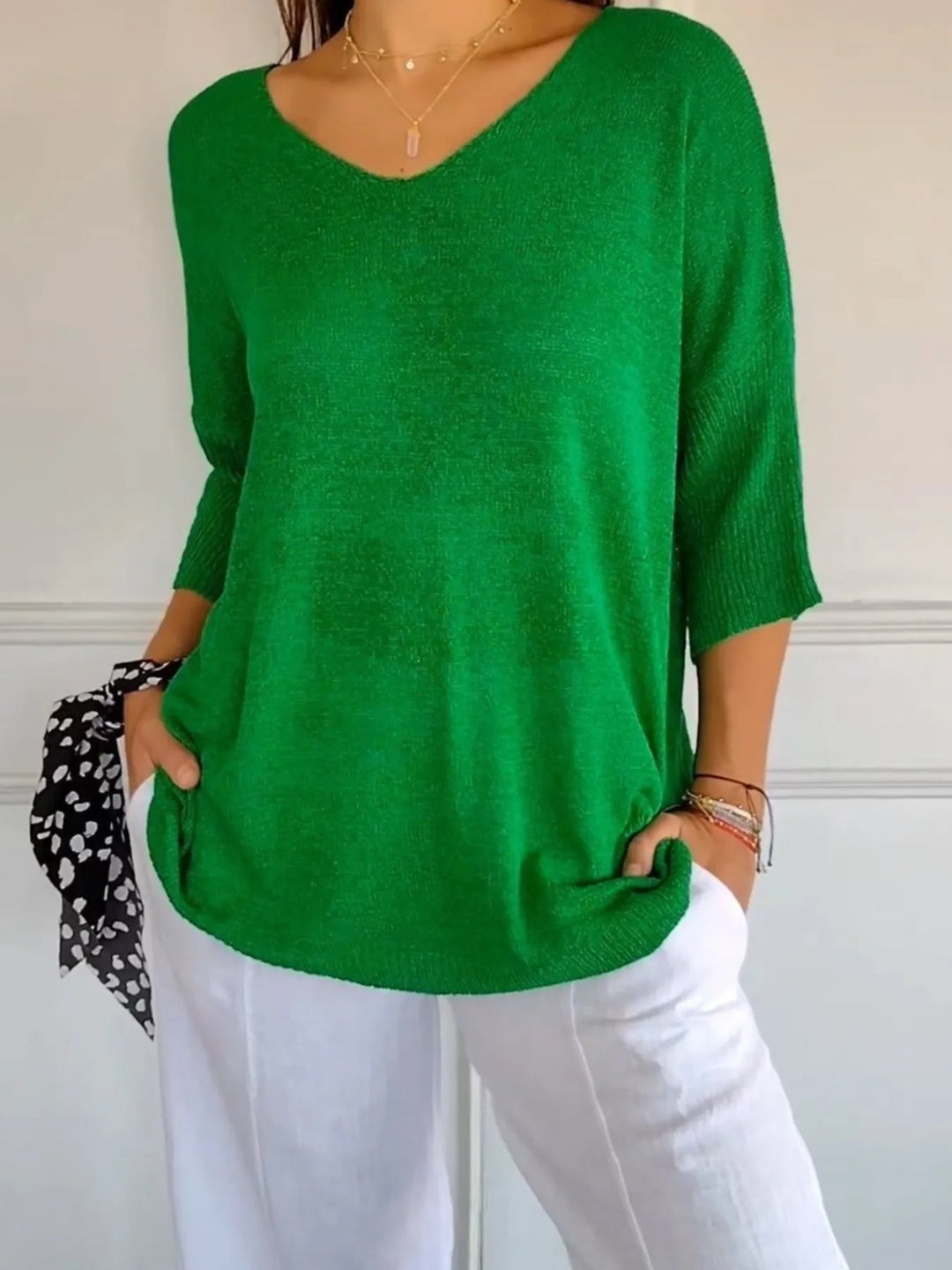 Green lightweight V neck sweater with 3/4 sleeves, styled with white pants