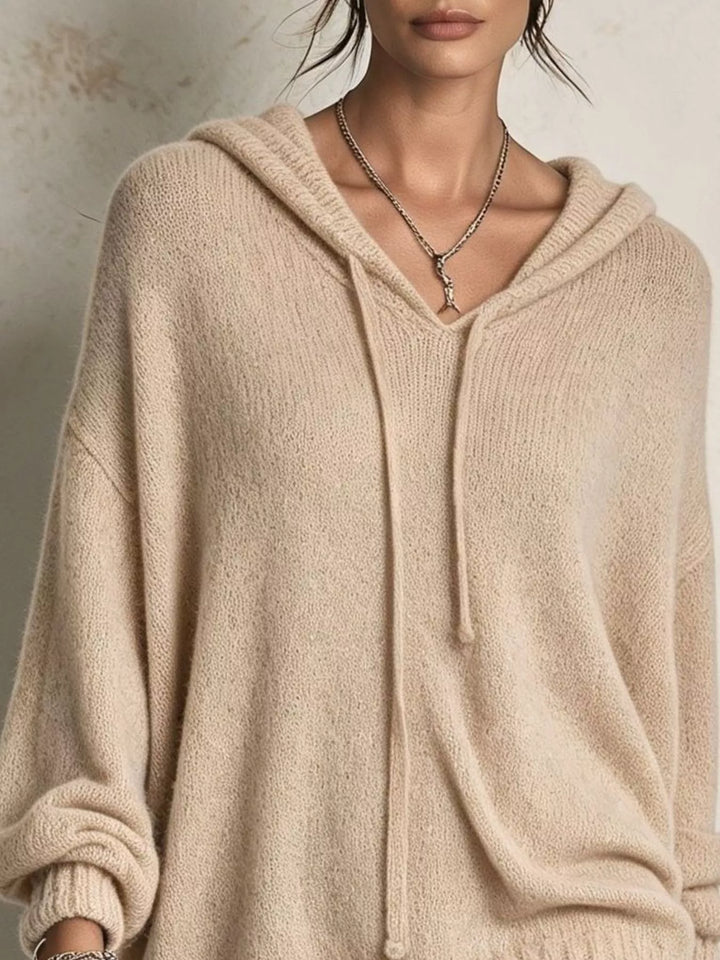 Close-up of the tan hooded sweater V neckline and drawstring