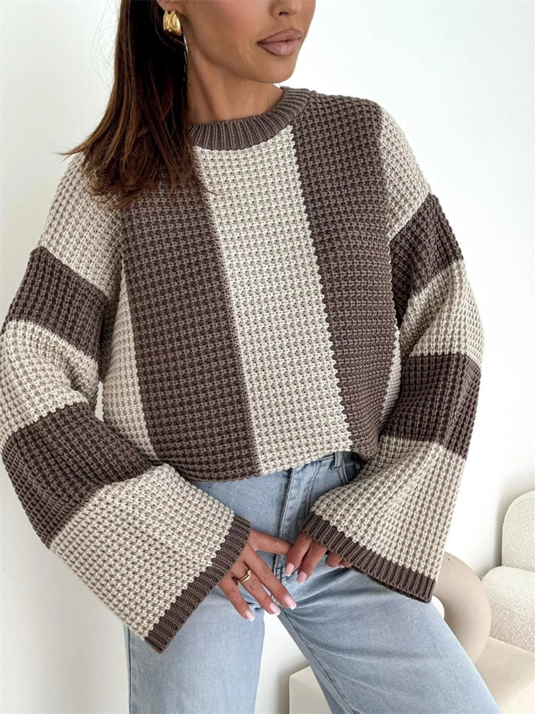 Oversized beige brown striped sweater styled with a taupe bag and jeans