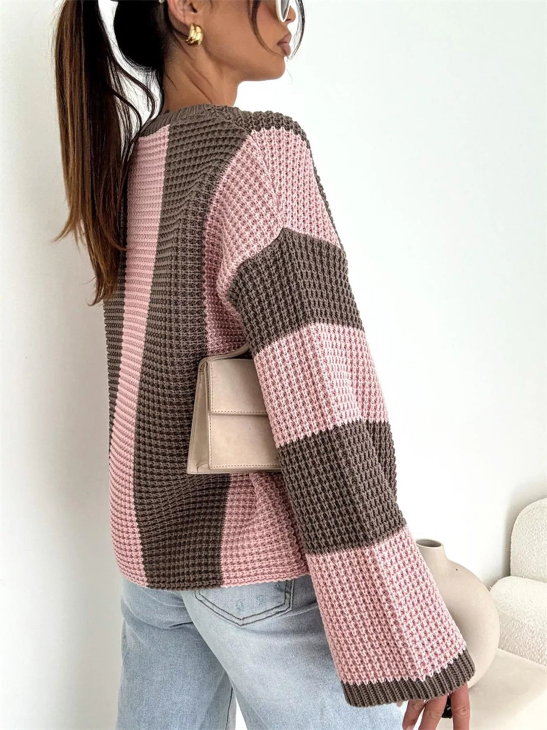 Back view of the pink and brown stripe waffle knit sweater