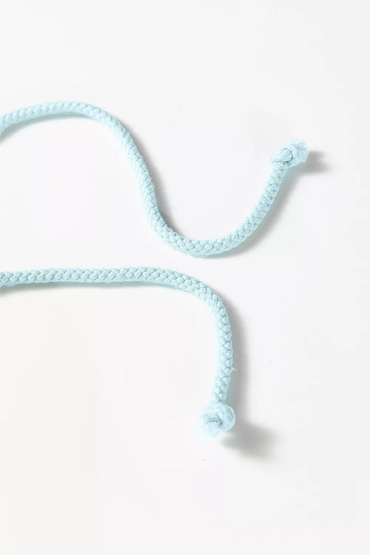 Drawstring cord with knotted ends in pastel blue on a white surface