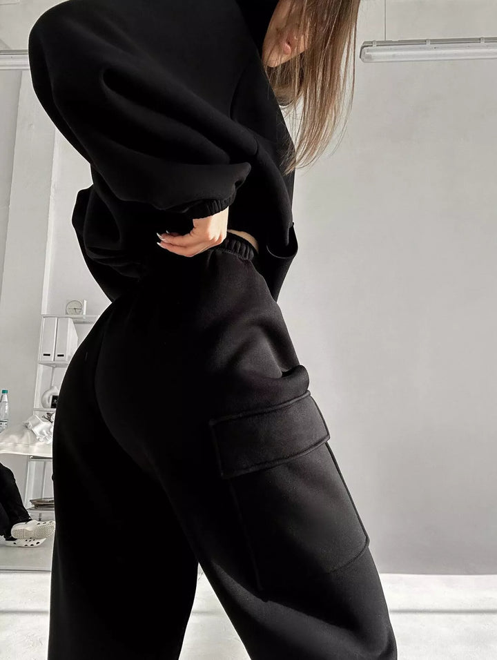 Black cargo jogger with side pocket and cropped hoodie hem, angled view