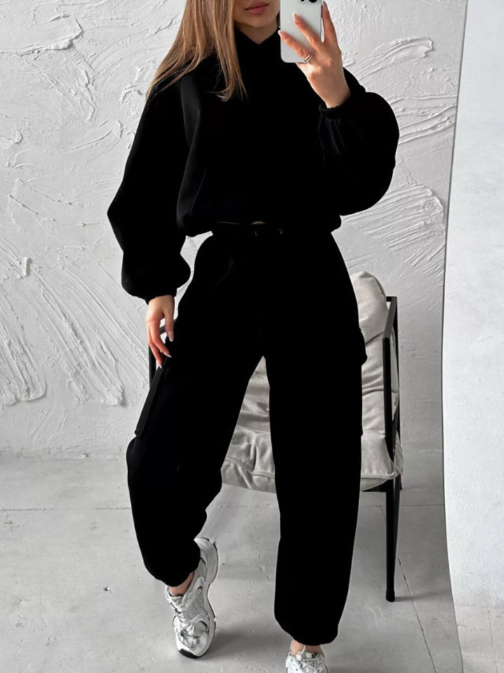 Black hoodie and cargo joggers set worn with white sneakers, mirror selfie