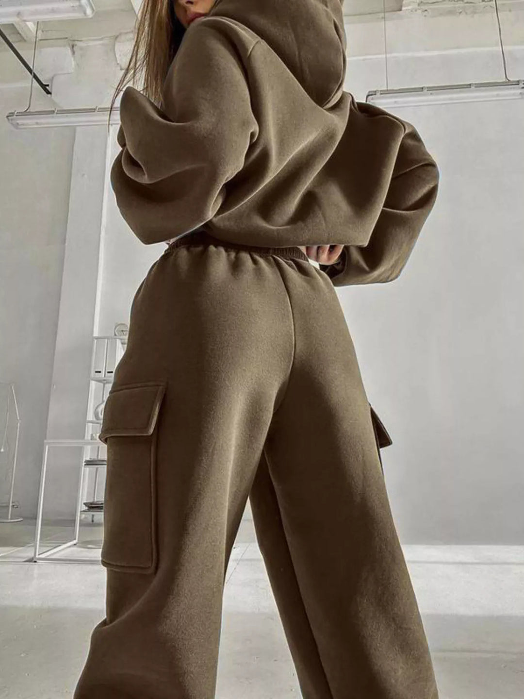 Olive sweatsuit side view showing the hood and cargo pocket on the jogger